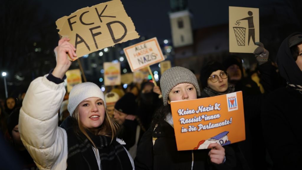 People Protest Against AfD Following AfD Meeting With Neo-NazisBERLIN, GERMANY - JANUARY 17: (EDITORS NOTE: Image contains profanity.) People gather in the city center to protest against the far-right Alternative for Germany (AfD) political party on January 17, 2024 in Berlin, Germany. Several thousand people gathered today in Berlin in one of a number of similar protests this week across Germany. The AfD is under heavy public scrutiny following the recent revelation that Roland Hartwig, a former AfD Bundestag parliamentarian and until recently an advisor to AfD co-leader Alice Weidel, had taken part in a meeting last year with neo-Nazis, including Austrian far-right extremist Martin Sellner, at a villa near Potsdam. According to the investigative group Correctiv participants at the meeting discussed how to possibly introduce legislative measures to enable the mass expulsion of immigrants from Germany, as well as German citizens with immigrant roots and German citizens who have helped refugees. News of the meeting has prompted renewed calls for banning the AfD.   (Photo by Sean Gallup/Getty Images)