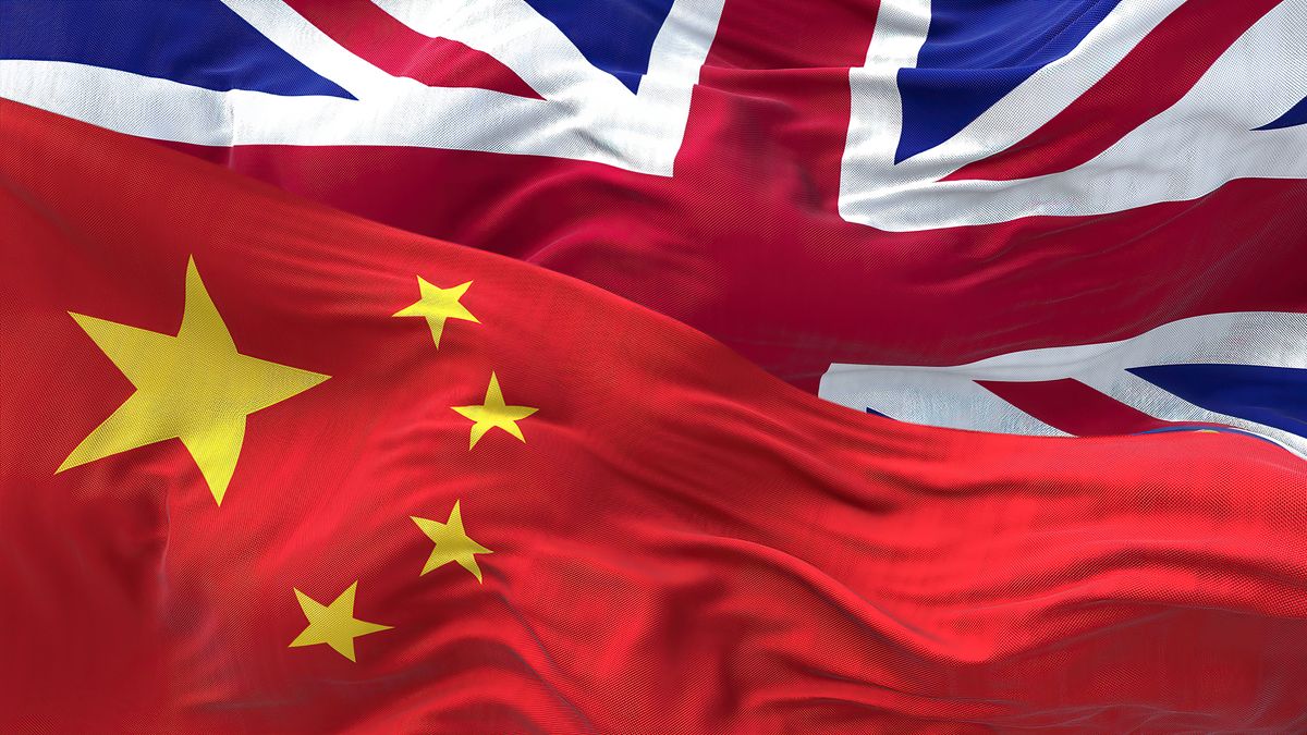 The,Flags,Of,China,And,The,United,Kingdom,Waving,In
The flags of China and the United Kingdom waving in the wind. International relations and diplomacy. Global Finance and economy after the Brexit