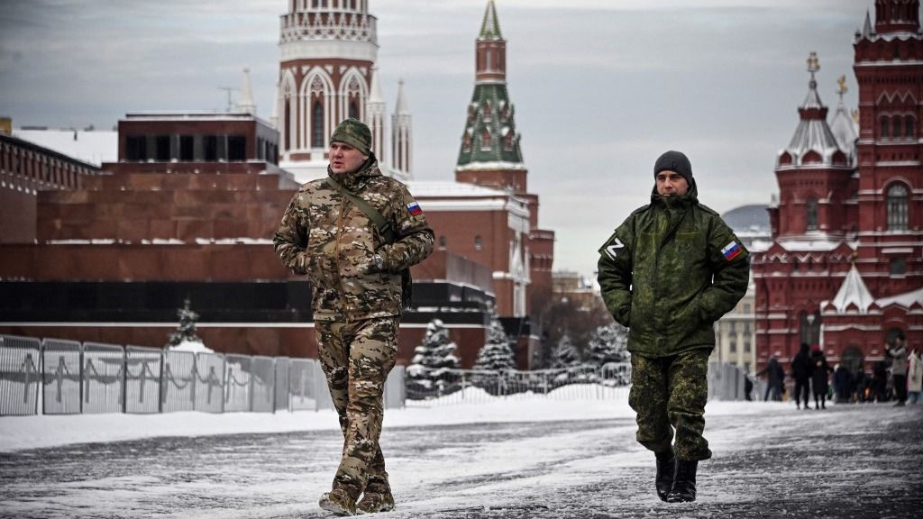 Men wearing military uniforms bearing a Z letter, an insignia of Russian troops in Ukraine, walk along the Red square in Moscow, on January 19, 2024. (Photo by Alexander NEMENOV / AFP)