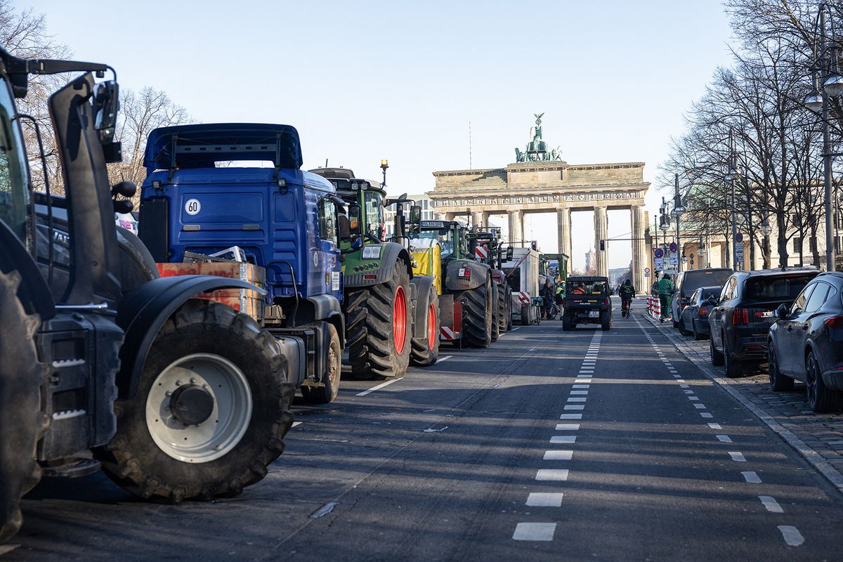 One hundred farmers are holding a vigil in front of the Brandenburg Gate, with approximately 50 to 100 tractors parked directly on Strasse des 17. Juni. Some of the demonstrators are planning to hold out until they reach an agreement with the federal government, despite the crisp -1 degree outside temperature. (Photo by Marten Ronneburg/NurPhoto) (Photo by Marten Ronneburg / NurPhoto / NurPhoto via AFP)
