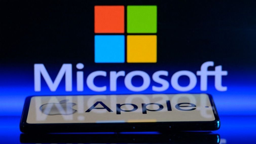 Microsoft - Apple - Photo IllustrationThe Apple logo is being displayed on a smartphone with Microsoft visible in the background in this photo illustration in Brussels, Belgium, on January 13, 2024. (Photo Illustration by Jonathan Raa/NurPhoto) (Photo by Jonathan Raa / NurPhoto / NurPhoto via AFP)