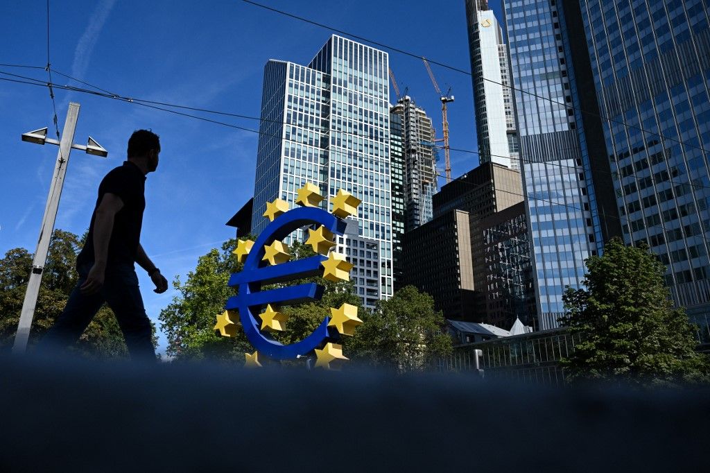A person walks past the Euro currency sign in front of the former European Central Bank (ECB) building on September 14, 2023 ahead of the meeting of the governing council of the ECB in Frankfurt am Main, western Germany. (Photo by Kirill KUDRYAVTSEV / AFP)