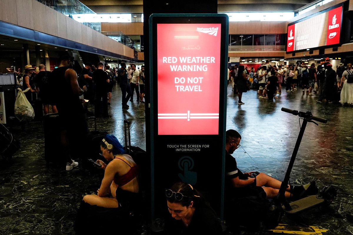 A board warning the Rail passengers about the high temperatures and its impact on the rail traffic is pictured at Euston train station in central London, on July 19, 2022, as services were cancelled due to a trackside fire, and as the country experiences an extreme heat wave. All services to and from London Euston were on Tuesday suspended, as emergency services dealt with a fire on the trackside. After the UK's warmest night on record, the Met Office said 40.2C had been provisionally recorded by lunchtime at Heathrow Airport, in west London, taking the country into uncharted territory. (Photo by Niklas HALLE'N / AFP)