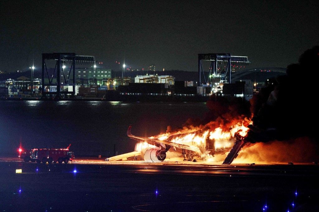 This photo provided by Jiji Press shows a Japan Airlines plane on fire on a runway of Tokyo's Haneda Airport on January 2, 2024. A Japan Airlines plane was in flames on the runway of Tokyo's Haneda Airport on January 2 after apparently colliding with a coast guard aircraft, television reports said. (Photo by JIJI PRESS / AFP) / Japan OUT