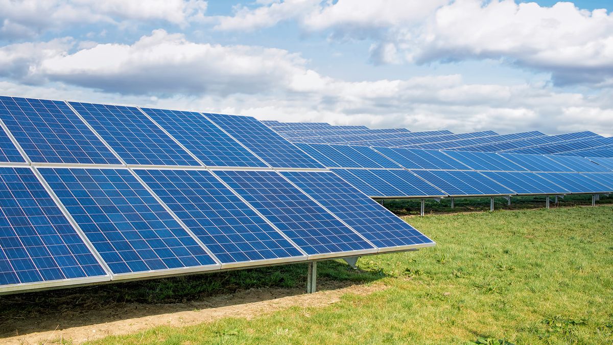 Solar Farm. Green Fields Blue Sky, Sustainable Renewable Energy.