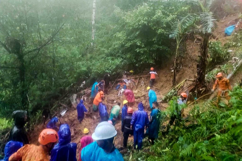 This handout photo taken and released by the Municipality of Monkayo on January 18, 2024 shows rescuers conducting a rescue and retrieval operation, a day after a landslide hit a house in Monkayo, where at least seven people were killed, a disaster official said, with the death toll expected to rise. The incident happened in the morning in a mountainous gold mining region of Davao de Oro province on Mindanao island, where heavy rain has triggered flooding and landslides this week. (Photo by Handout / Municipality of Monkayo / AFP) / RESTRICTED TO EDITORIAL USE - MANDATORY CREDIT "AFP PHOTO /  MUNICIPALITY OF MONKAYO" - NO MARKETING NO ADVERTISING CAMPAIGNS - DISTRIBUTED AS A SERVICE TO CLIENTS