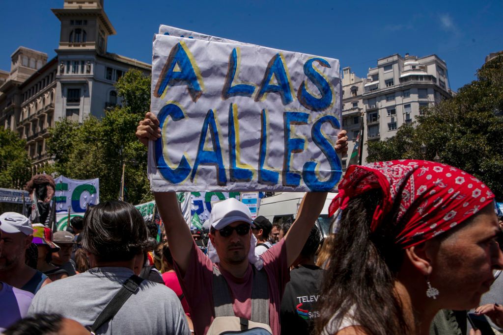 Argentina's Main Unions Stike Against Labor and Economic Reforms of President MileiBUENOS AIRES, ARGENTINA - JANUARY 24: A protester holds a banner during a national strike against policies of President Javier Milei called by worker's union CGT on January 24, 2024 in Buenos Aires, Argentina. On December 20, ten days after taking office, libertarian President Javier Milei put forward a decree and a set of bills aiming to amend or reform over 300 laws. (Photo by Ricardo Ceppi/Getty Images)