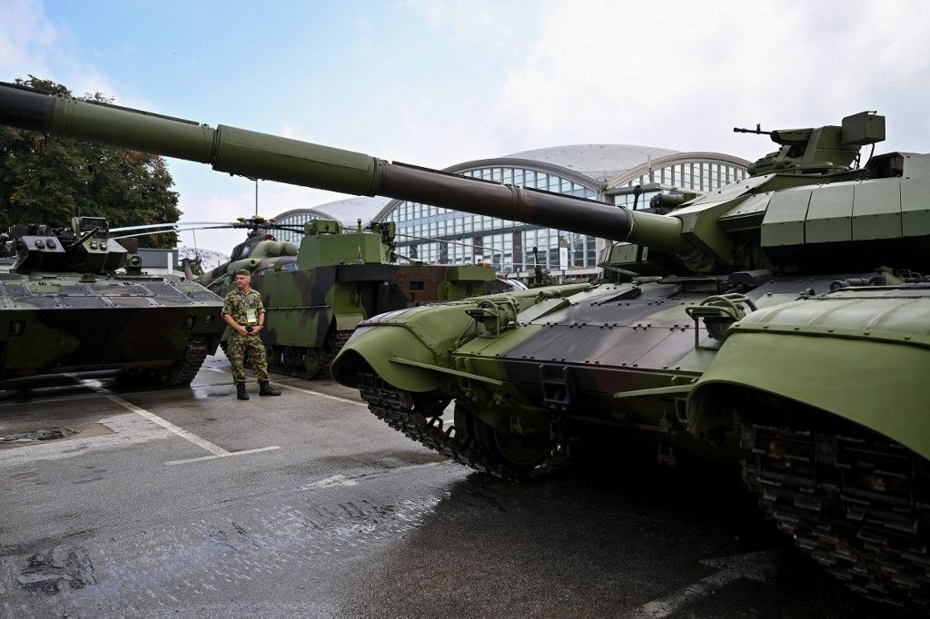 A Serbian Army personnel stands guard next to armoured vehicles at the 11th International Armament and Military Equipment Fair – PARTNER 2023, in Belgrade on September 25, 2023. (Photo by Andrej ISAKOVIC / AFP)