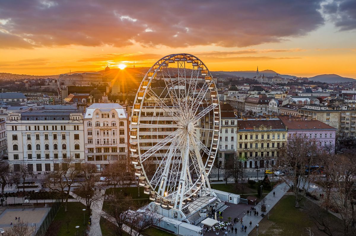 Budapest,,Hungary,-,Aerial,View,Of,Budapest,Eye,,The,FamousBudapest, Hungary - Aerial view of Budapest Eye, the famous ferris wheel of Budapest with Buda Castle Royal Palace and an amazing sunset at background. The wheel has been located at Elisabeth Square