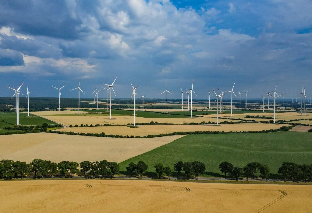 Wind energy25 June 2022, Brandenburg, Sieversdorf: Dark rain clouds pass over the landscape with a wind energy park in the Oder-Spree district (aerial photo taken with a drone). Photo: Patrick Pleul/dpa (Photo by PATRICK PLEUL / DPA / dpa Picture-Alliance via AFP)
