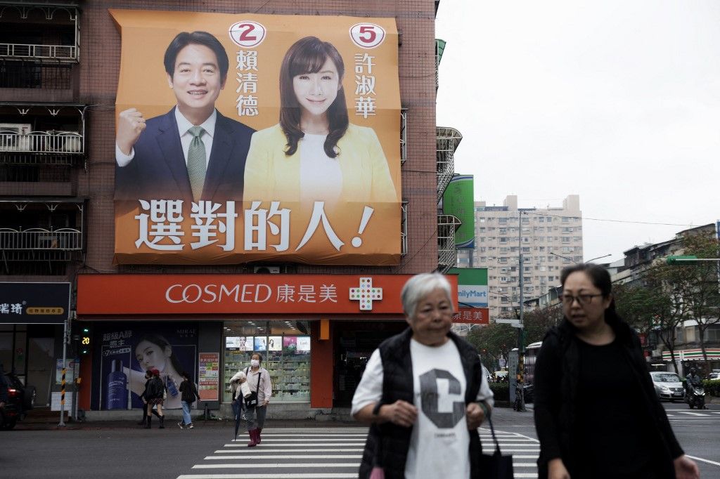 An election campaign billboard showing Taiwan's ruling Democratic Progressive Party (DPP) presidential candidate Lai Ching-te (L) and legislative candidate Hsu Shu-Hua are seen on a building near the Songshan train station in Taipei on December 28, 2023. (Photo by I-Hwa CHENG / AFP)