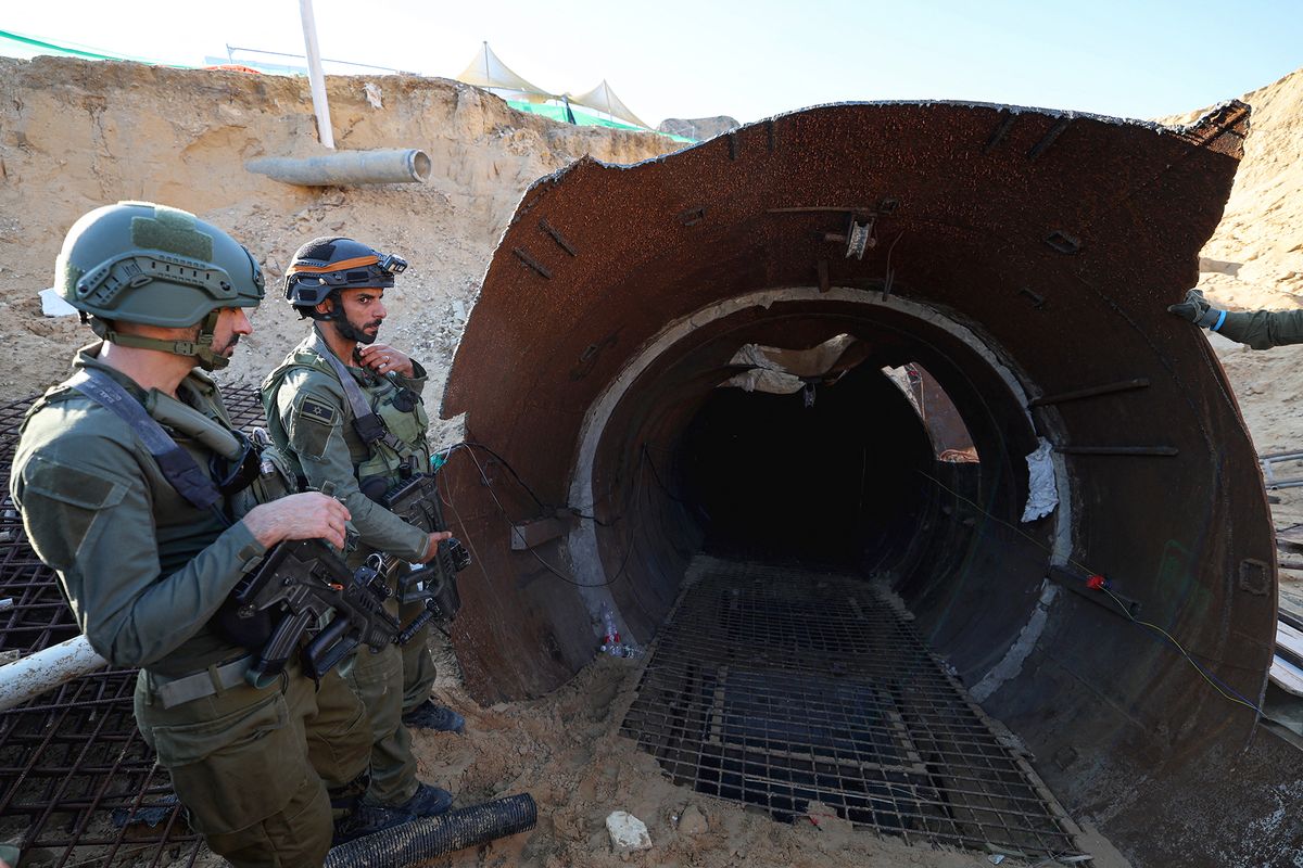 In this picture taken during a media tour organised by the Israeli military on December 15, 2023, soldiers stand at the entrance of a tunnel that Hamas reportedly used to attack Israel through the Erez border crossing on October 7. The Israeli army said on December 17, 2023 it had uncovered the biggest Hamas tunnel in the Gaza Strip so far, just a few hundred metres from the Erez border crossing. (Photo by JACK GUEZ / AFP) / “The erroneous mention[s] appearing in the metadata of this photo by JACK GUEZ has been modified in AFP systems in the following manner: [Beit Hanun, Palestinian territories] instead of [Erez, Palestinian territories in the iptc fields]. Please immediately remove the erroneous mention[s] from all your online services and delete it (them) from your servers. If you have been authorized by AFP to distribute it (them) to third parties, please ensure that the same actions are carried out by them. Failure to promptly comply with these instructions will entail liability on your part for any continued or post notification usage. Therefore we thank you very much for all your attention and prompt action. We are sorry for the inconvenience this notification may cause and remain at your disposal for any further information you may require.”