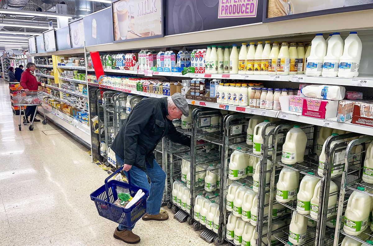 A customer shops for milk inside a Sainsbury's supermarket in east London on February 20, 2023. British retail sales rebounded surprisingly in January on falling fuel costs and discounting by online and physical stores, official data showed Friday. At the same time, food sales dropped 0.5 percent, the ONS said, following large price rises over the past year. (Photo by Daniel LEAL / AFP)