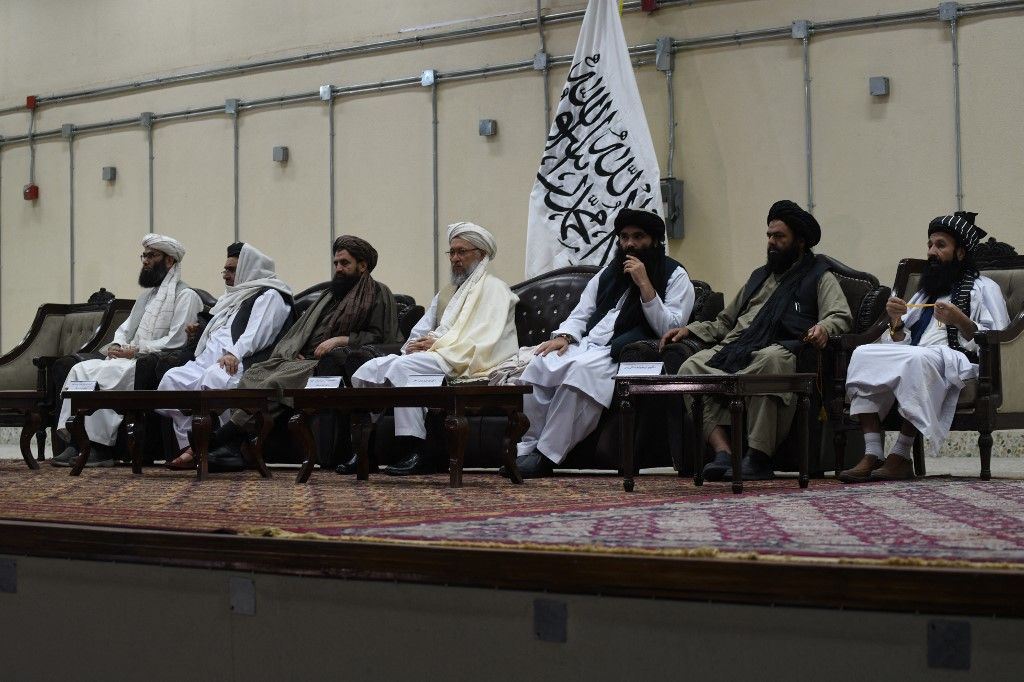 Taliban leaders participate in a conference for the reading of the official decree of the Islamic Emirate of Afghanistan’s (IEA) supreme leader on the ban of poppy cultivation and all kind of narcotics, in Kabul on April 3, 2022. (Photo by Ahmad SAHEL ARMAN / AFP)