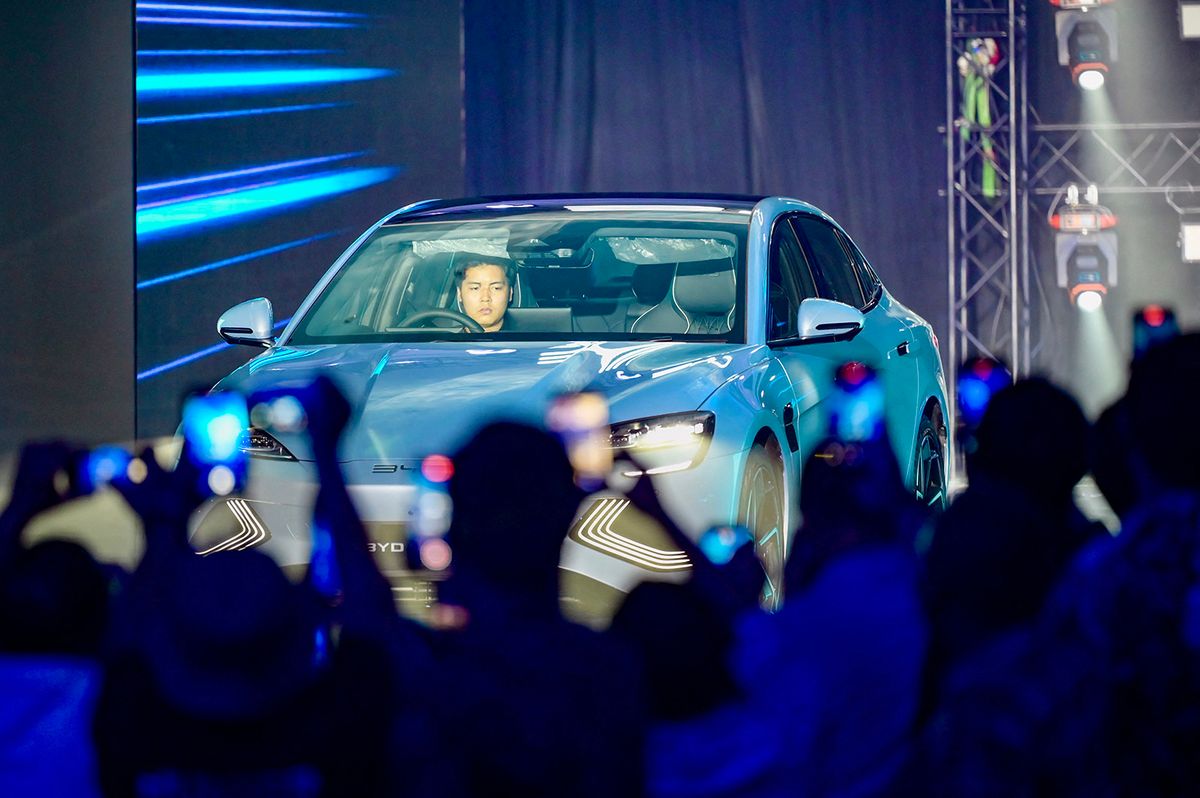 Journalists record video using their smart phone during the launch of the Chinese-made BYD brand in Jakarta, on January 18, 2024, and at the same time introduced 3 types of battery-powered vehicles (EV, electric vehicle) that will be sold in Indonesia, with an investment of 1.3 billion US dollars. (Photo by BAY ISMOYO / AFP)