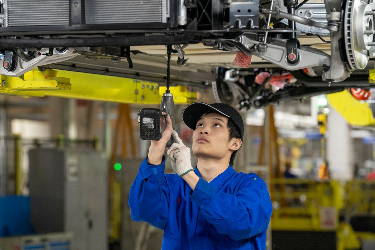 BYD An employees install parts on a BYD vehicle in the BYD factory in Changzhou, China on Nov. 14, 2023. (Photo by Raul Ariano / Jiangsu Information Office)