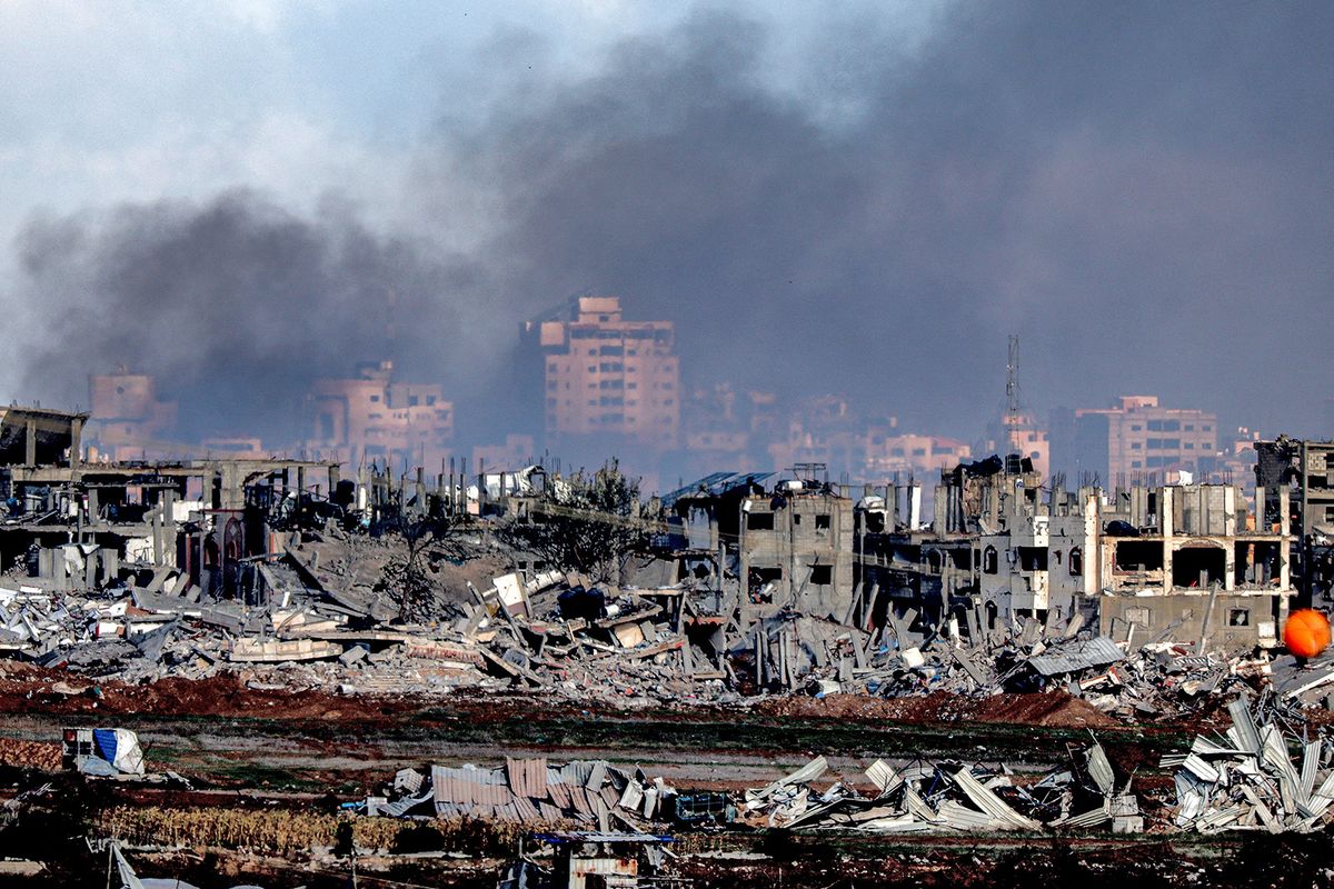 This picture taken on January 3, 2024 shows a view of buildings destroyed by Israeli bombardment in the central Gaza Strip from a position across the border in southern Israel amid the ongoing conflict between Israel and the Palestinian militant group Hamas. (Photo by JACK GUEZ / AFP)