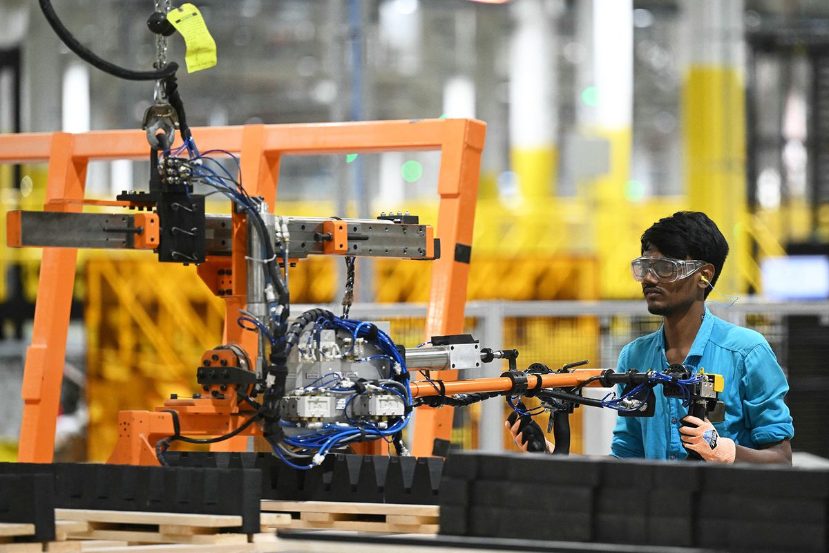 A worker operates a machine at the First Solar manufacturing facility in Sriperumbudur, Kanchipuram district, on January 11, 2024. (Photo by R.Satish BABU / AFP)