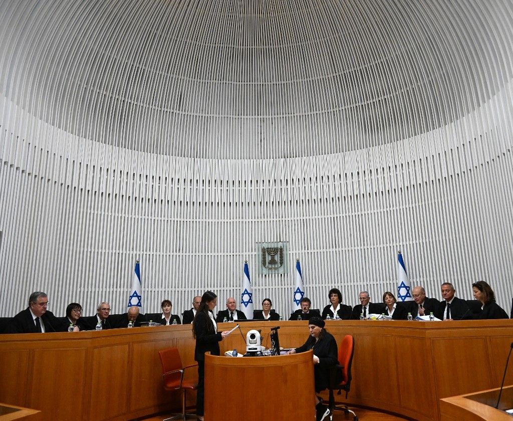President of the Israeli Supreme Court Esther Hayut and all fifteen judges assemble to hear petitions against the 'reasonableness clause' at the court premises in Jerusalem, on September 12, 2023. The petitions call to strike down the clause passed by Israel's hardline government through parliament in July, a major element of a controversial judicial overhaul that has triggered mass protests and divided the nation. The amendment limits the powers of the top court to review and sometimes overturn government decisions, which opponents say paves the way to authoritarianism. (Photo by DEBBIE HILL / POOL / AFP)