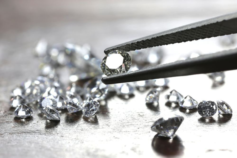 Brilliant,Cut,Diamond,Held,By,Tweezers