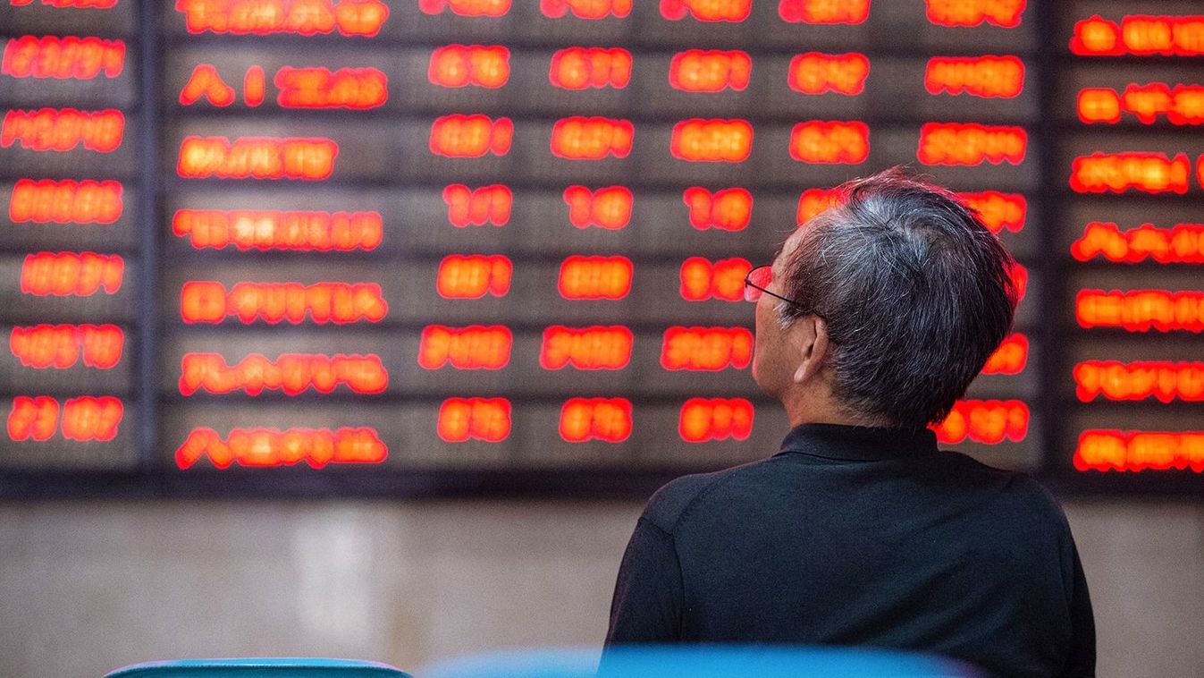 An investor looks at screens showing stock market movements at a securities company in Nanjing in China's eastern Jiangsu province on July 6, 2020. Shanghai stocks surged on July 6 to a more than two-year high as investors piled in following a combination of rosy predictions for the market and strong economic data. (Photo by AFP) / China OUT