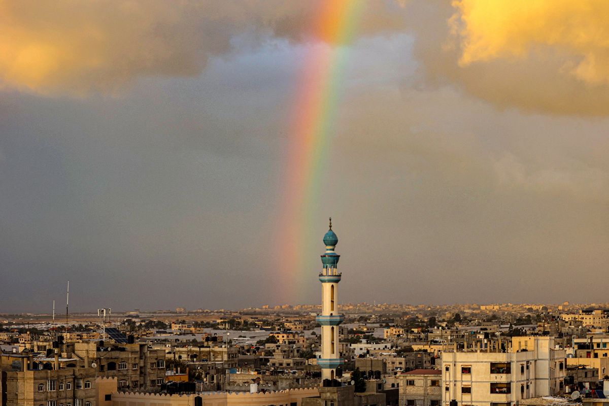 A picture taken from Rafah shows a rainbow over the southern Gaza Strip on January 11, 2024, amid ongoing battles between Israel and Palestinian Hamas militants in the Gaza Strip. (Photo by AFP)