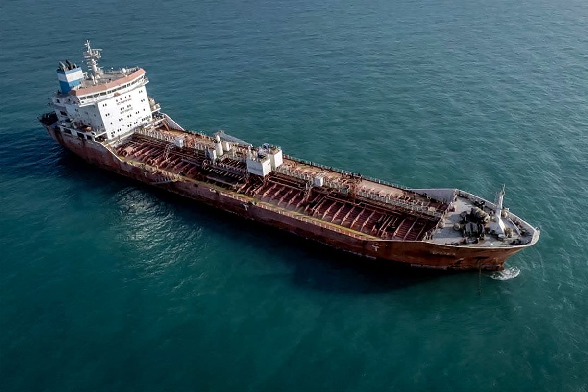 This picture taken on October 31, 2022 shows a view of an oil tanker, seized by Iranian naval forces at the Gulf port of Bandar Abbas in southern Iran. Iran said the foreign-registered ship was smuggling fuel in the Gulf and arrested its crew, according to local media. "The navy of the Islamic Revolutionary Guard Corps has seized a foreign tanker carrying 11 million litres of smuggled fuel", said Mojtaba Ghahremani, the judiciary chief for Hormozgan province, according to the Tasnim news agency. It is not known when the vessel was seized, or what flag it sailed under. (Photo by IRNA / AFP)