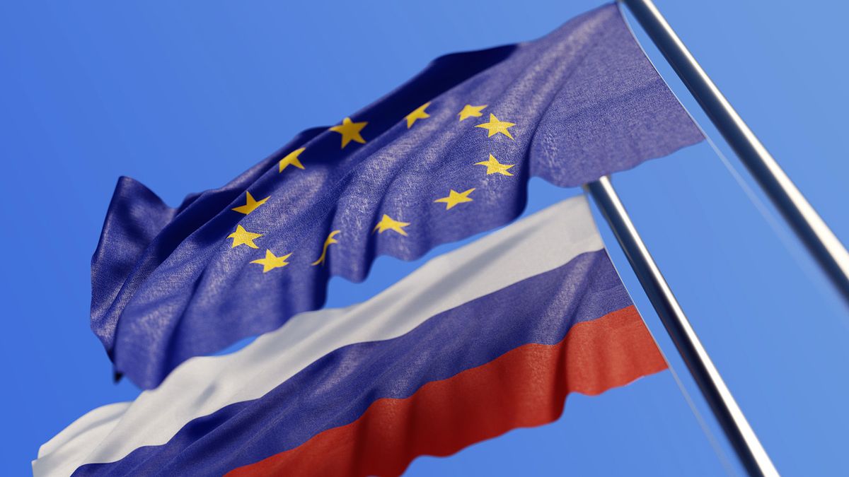 European Union And Russians Flags Waving With Wind On Blue Sky