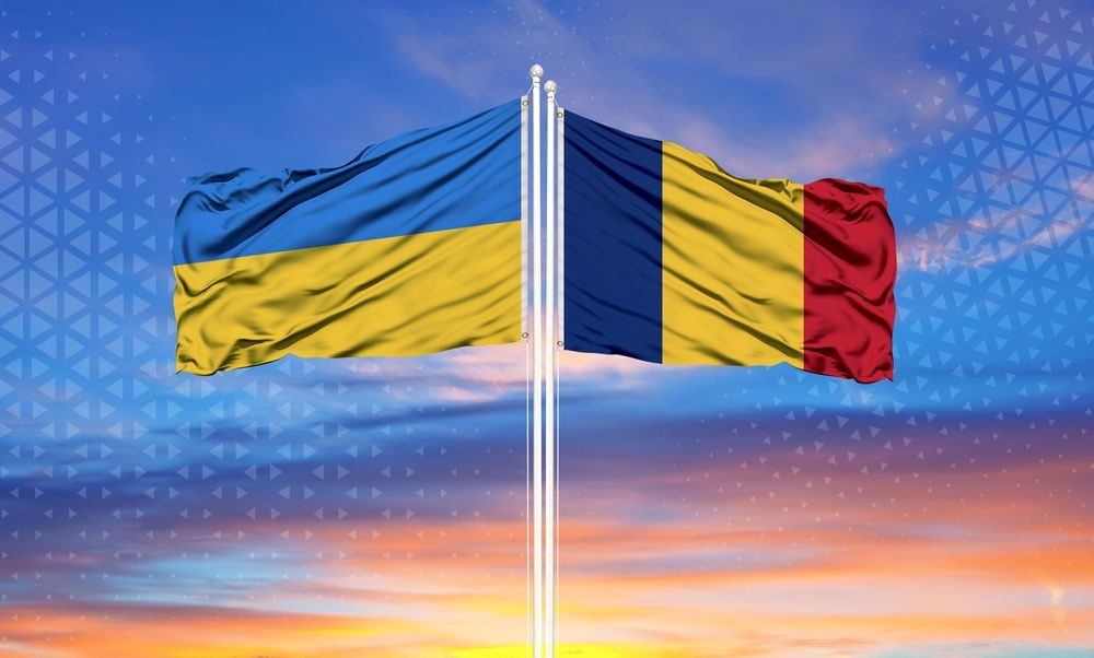 Romania,And,Ukraine,Two,Flags,On,Flagpoles,And,Blue,Sky