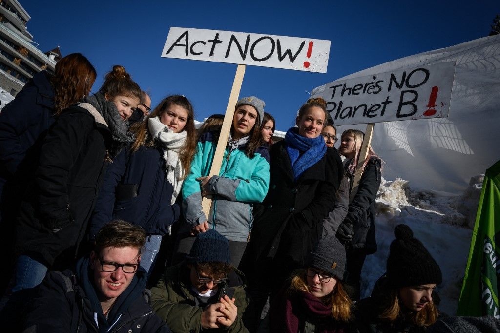 Student gather around placards during a "strike for climate" held on the sidelines of the World Economic Forum (WEF) annual meeting, on January 25, 2019 in Davos, eastern Switzerland. Swedish 16-year-old Greta Thunberg has inspired a wave of climate protests by schoolchildren around the world after delivering a fiery speech at the UN climate summit in Katowice, Poland last month. (Photo by Fabrice COFFRINI / AFP)