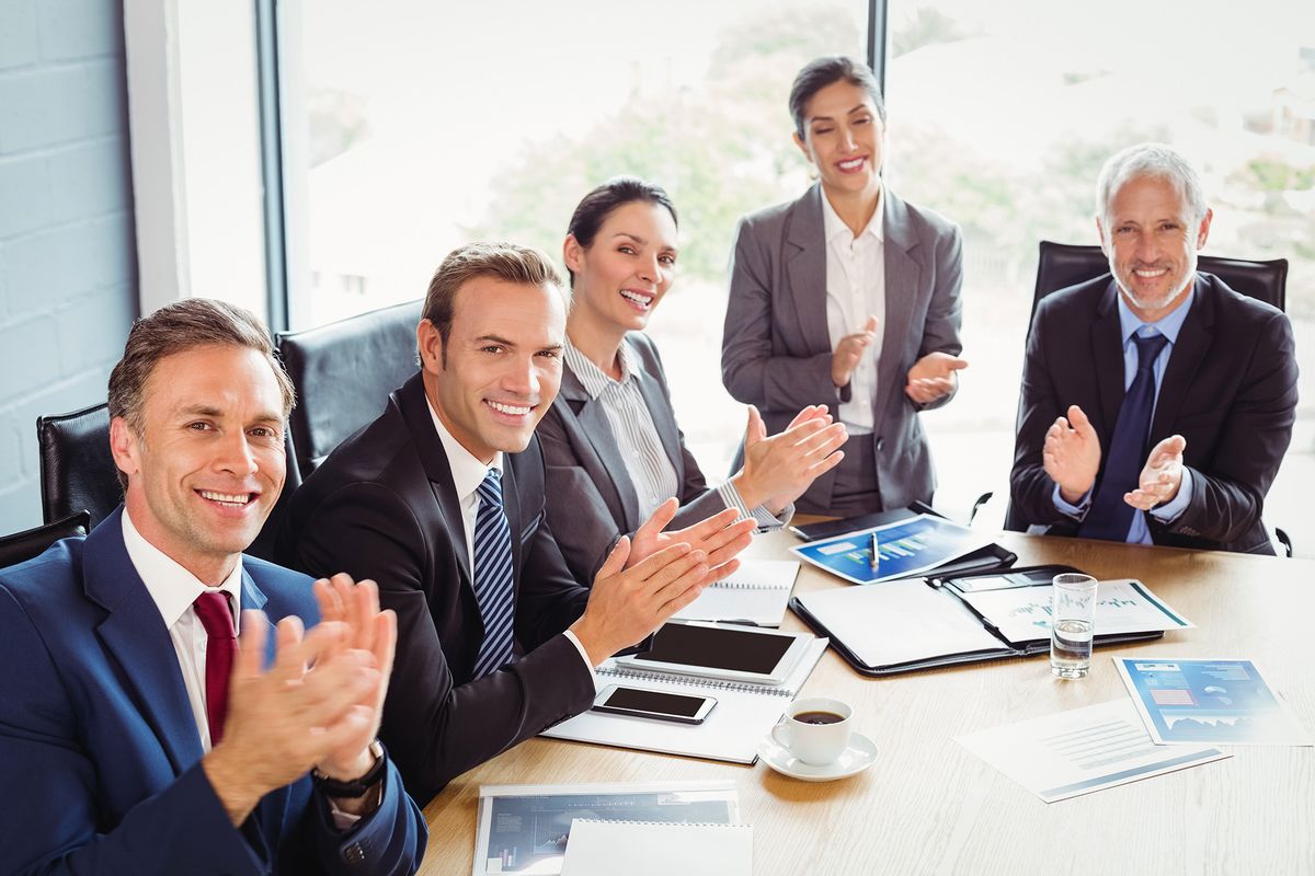 Portrait,Of,Businesspeople,Applauding,In,Conference,Room,During,Meeting