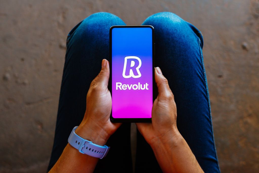 In this photo illustration, the Revolut logo is displayed on
