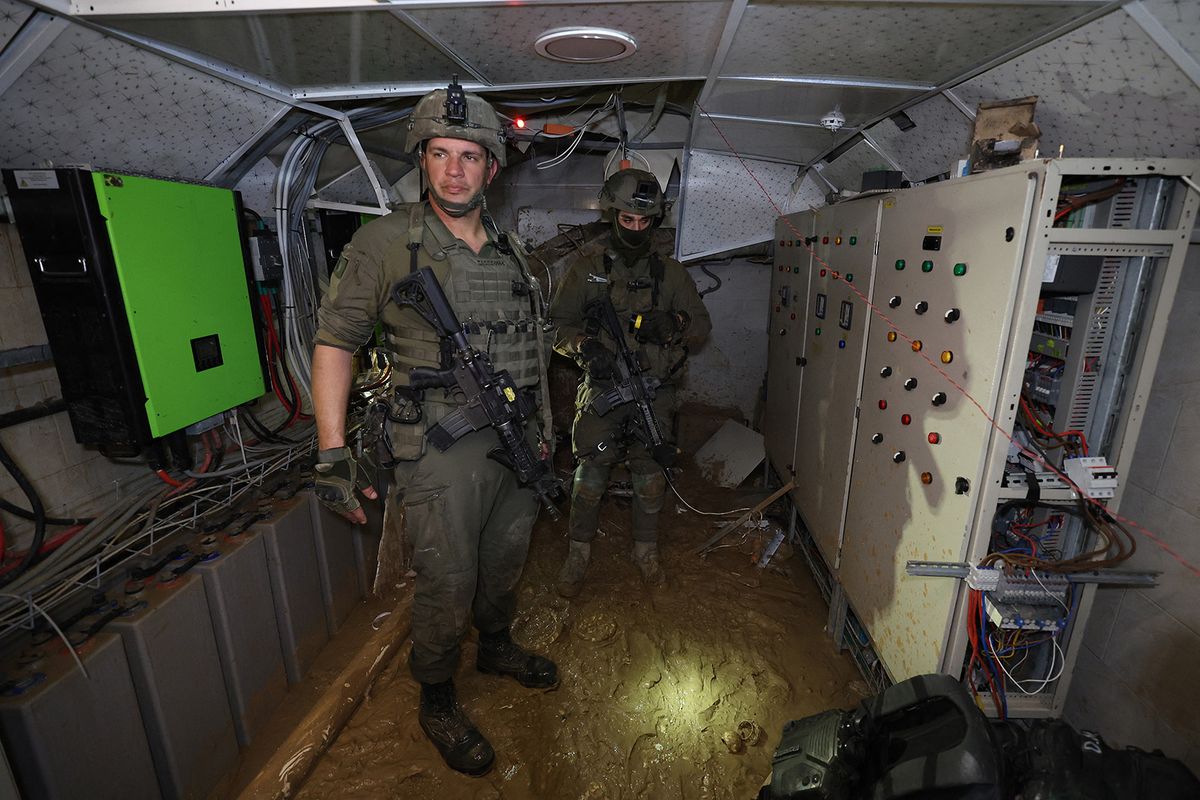 --PHOTO TAKEN DURING A CONTROLLED TOUR AND SUBSEQUENTLY EDITED UNDER THE SUPERVISION OF THE ISRAELI MILITARY-- This picture taken during a media tour organised by the Israeli military on February 8, 2024, shows Israeli soldiers inside a tunnel that the army claimed is a "Hamas command tunnel" under a compound of the United Nations Relief and Works Agency for Palestine Refugees (UNRWA) in Gaza City, amid the continuing war between Israel and the Palestinian militant group. (Photo by JACK GUEZ / AFP)