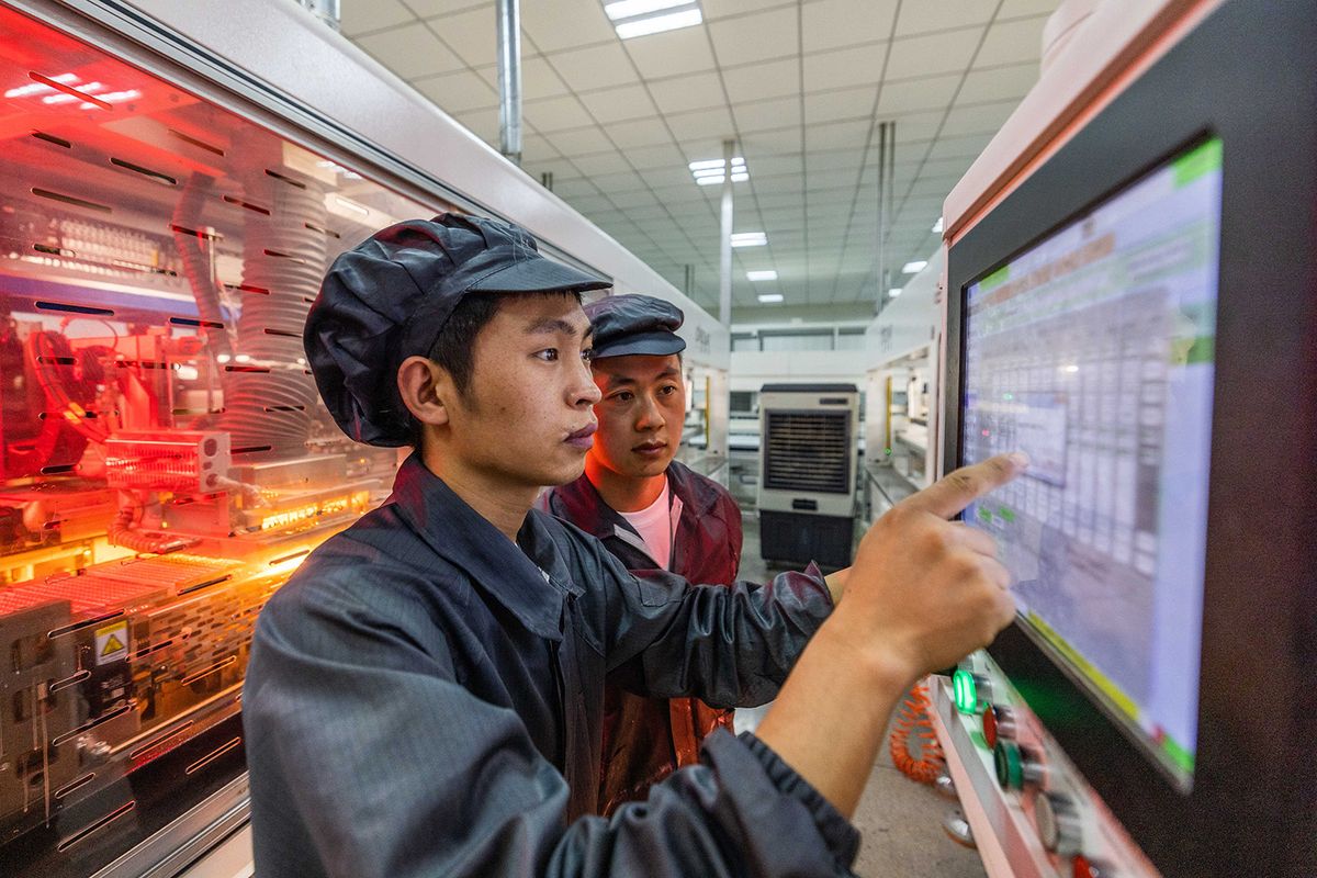 BIJIE, CHINA - JUNE 11, 2023 - Workers work on a photovoltaic panel module production line at a new energy industrial park in Bijie, Southwest China's Guizhou province, June 11, 2023. (Photo by Costfoto/NurPhoto) (Photo by CFOTO / NurPhoto / NurPhoto via AFP)
