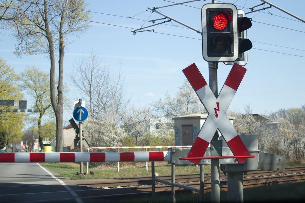 Red,Light,Of,The,Railway,Crossing,And,Lowered,Barrier,Blocking