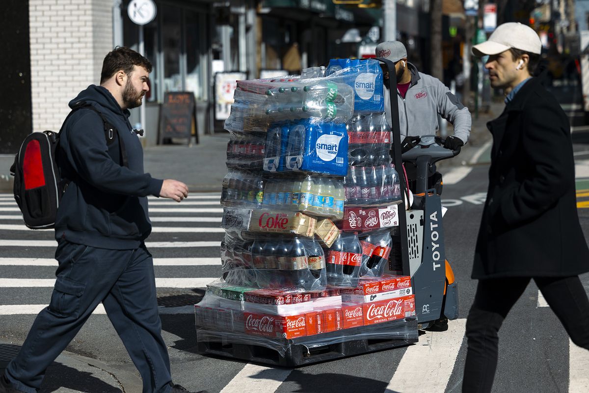 A worker moves a pallet of Coca-Cola products in New York, US, on Friday, Feb. 9, 2024. Coca-Cola Co. is scheduled to release earnings figures on February 13. Photographer: Angus Mordant/Bloomberg via Getty Images