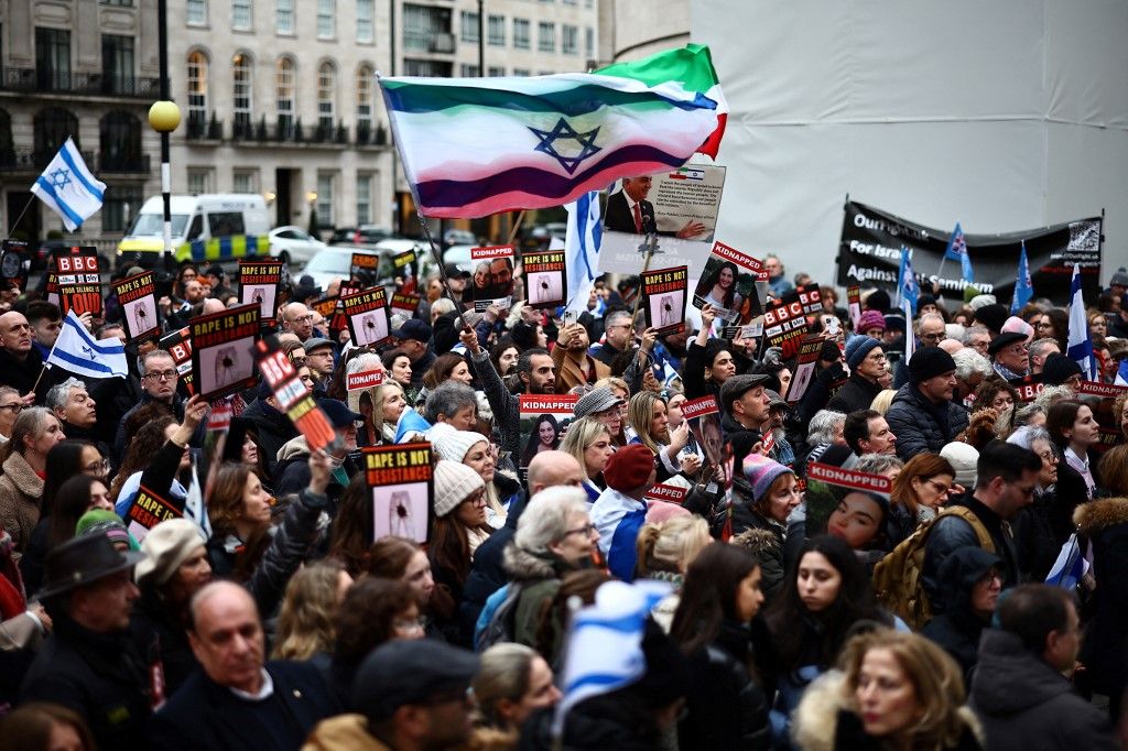 Protesters hold placards and wave Israeli flags as they take part in a demonstration "Rape is NOT resistance"  outside the BBC headquarters, in London, on February 4, 2024 to bring attention to the plight of the kidnapped Israeli women in Gaza who have been held by Hamas for over 110 days. Thousands of civilians, both Palestinians and Israelis, have died since October 7, 2023, after Palestinian Hamas militants based in the Gaza Strip entered southern Israel in an unprecedented attack triggering a war declared by Israel on Hamas with retaliatory bombings on Gaza. (Photo by HENRY NICHOLLS / AFP)