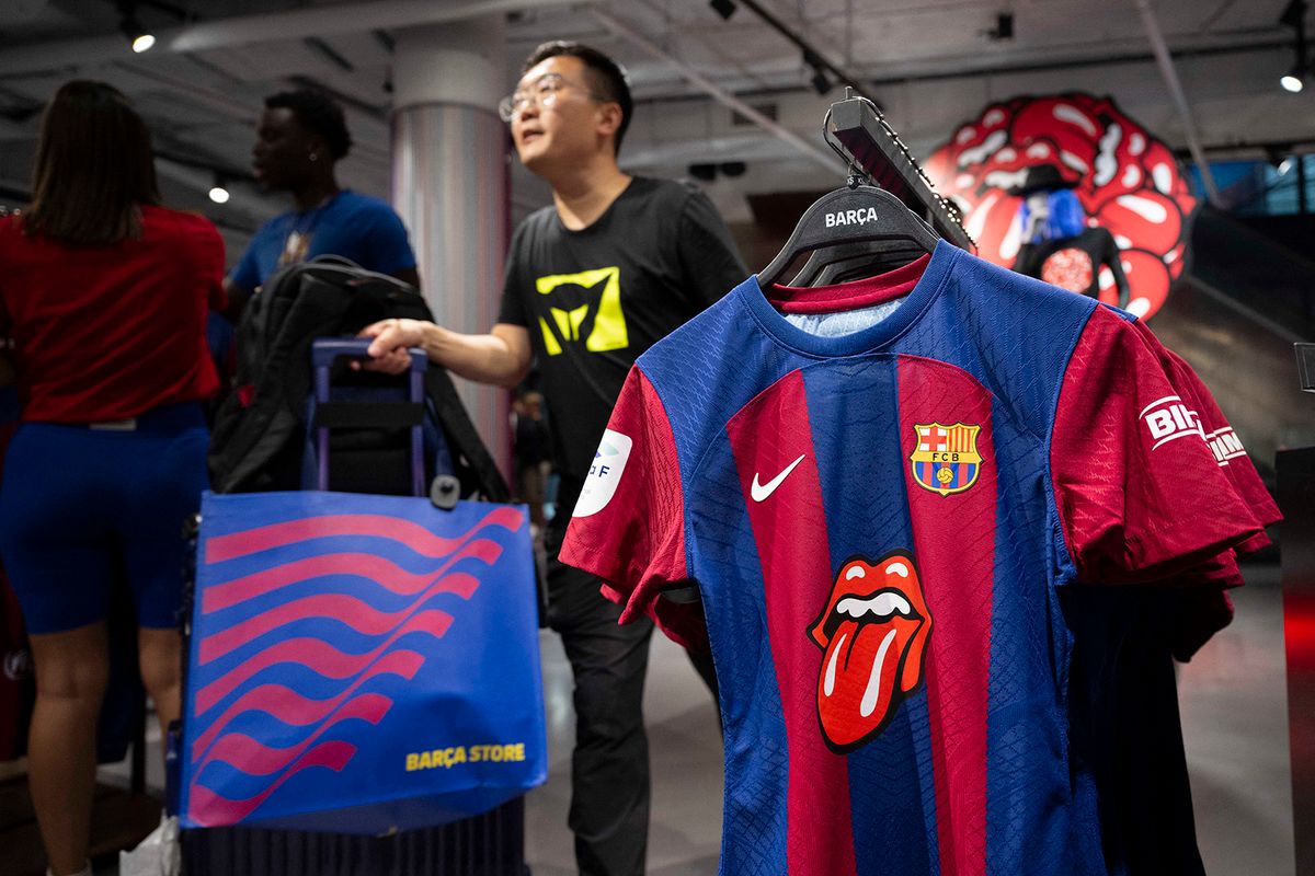 This picture taken on October 23, 2023 at the FC Barcelona store, in Barcelona, shows the club's new jersey featuring the famous logo of the Rolling Stones which Barcelona players will wear during the Clasico against Real Madrid later this month, as part of the club's sponsorship deal with streaming giants Spotify. (Photo by Josep LAGO / AFP)