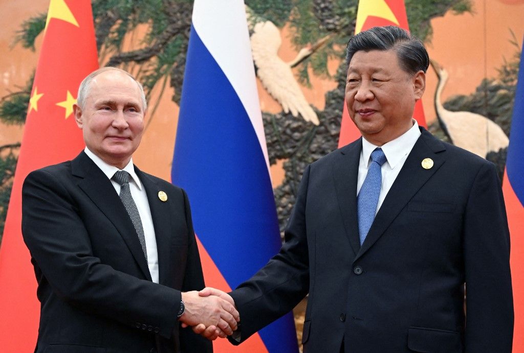 This pool photograph distributed by Russian state owned agency Sputnik shows Russia's President Vladimir Putin and Chinese President Xi Jinping shaking hands during a meeting in Beijing on October 18, 2023. (Photo by Sergei GUNEYEV / POOL / AFP)