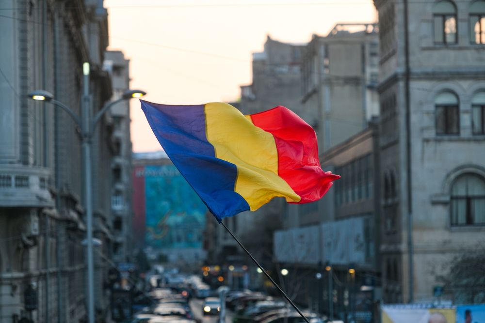 Romanian,Flag,With,Bucharest,City,Background