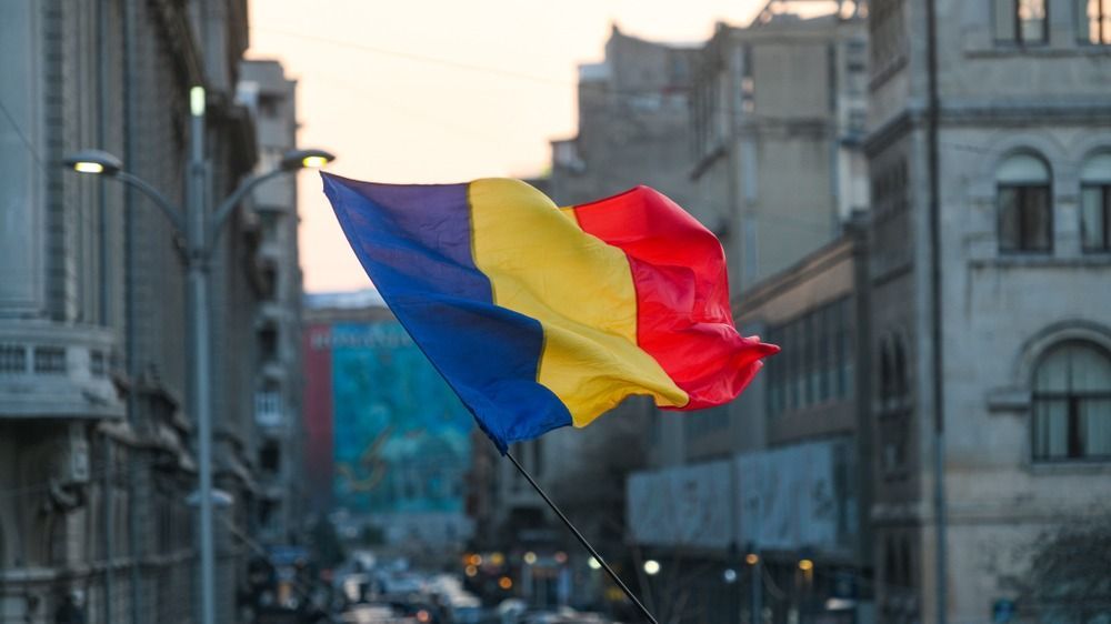 Romanian,Flag,With,Bucharest,City,Background
