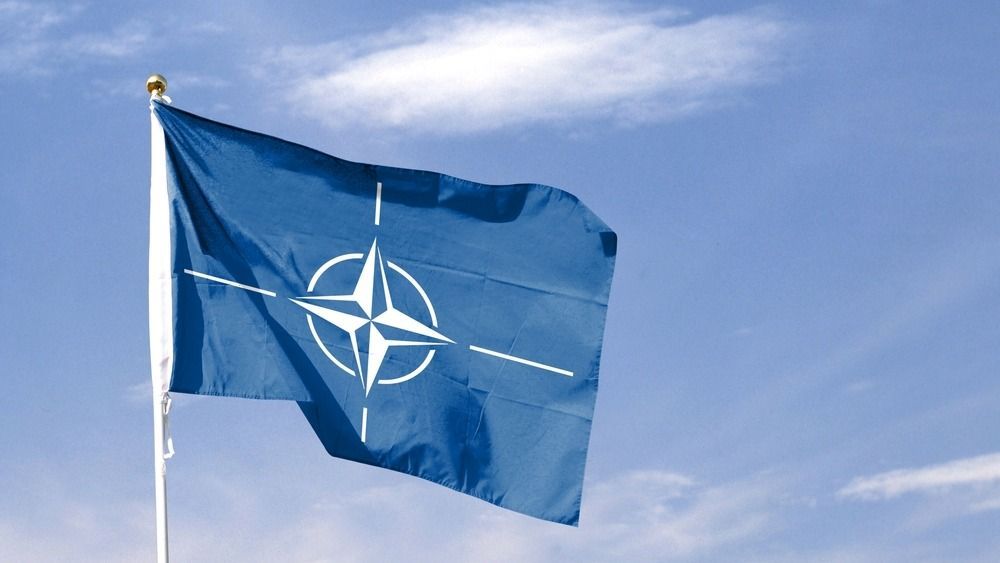 Nato,Flag,On,Cloudy,Sky.,Flying,In,The,Sky