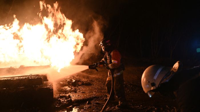 Ukrainian emergency personnel douse water to extinguish flames as they work at the site of a drone attack in Kharkiv, early on February 10, 2024. Seven people, including three children, were killed Saturday in a Russian drone attack on the city of Kharkiv in eastern Ukraine, the regional governor said. "Unfortunately the death toll from the occupiers' attacks on Kharkiv has risen to seven," Oleg Synegubov said on the Telegram social network. "Among them are three children: 7, 4 years old and a baby about six months old." (Photo by SERGEY BOBOK / AFP)