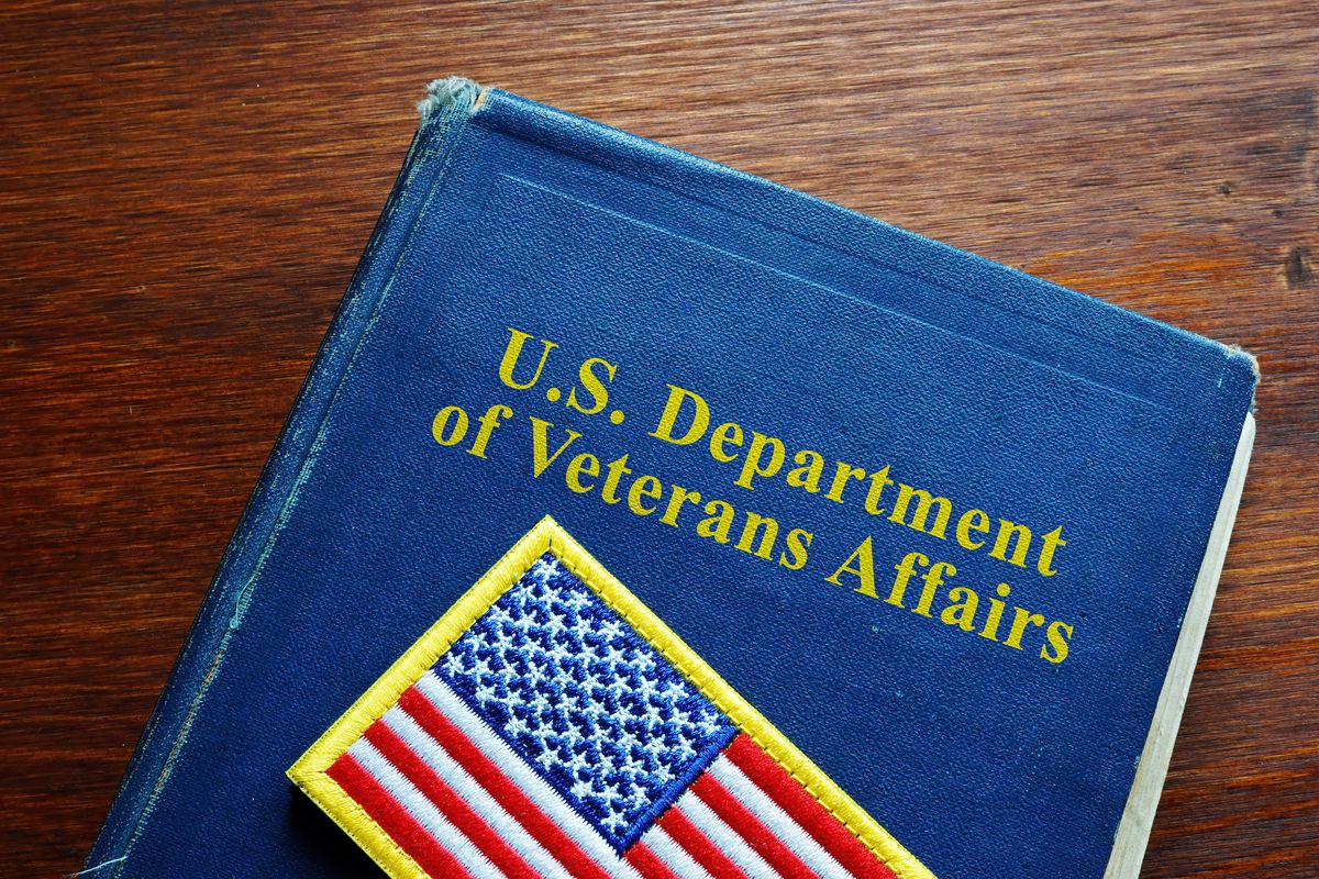 United States US Department of Veterans Affairs VA book and flag.United States US Department of Veterans Affairs VA book and flag.United States US Department of Veterans Affairs VA book and flag.