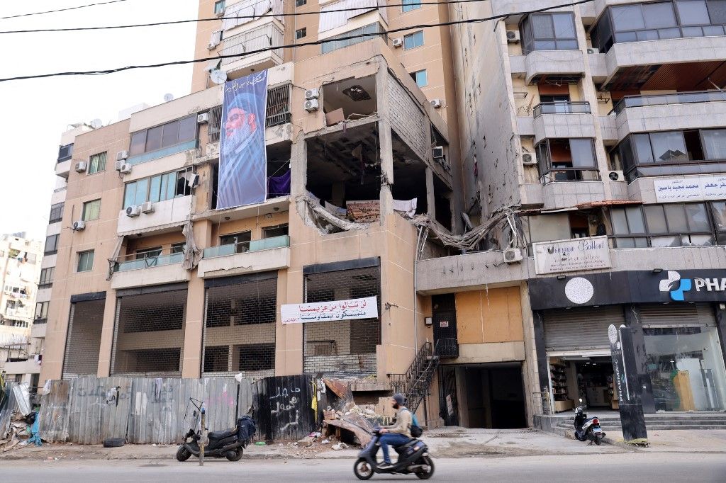 This photograph taken on January 8, 2024 shows a banner depicting Hezbollah Secretary General Hassan Nasrallah hanging on the building, which was hit by a drone attack, killing Hamas number two in a southern Beirut stronghold of Hamas ally Hezbollah on January 2, 2024. (Photo by ANWAR AMRO / AFP)