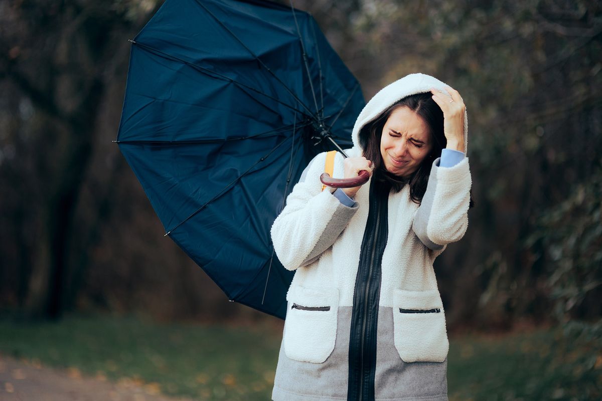 Woman,Struggling,During,Raining,Storm,Holding,An,Umbrella.,Unhappy,Girl