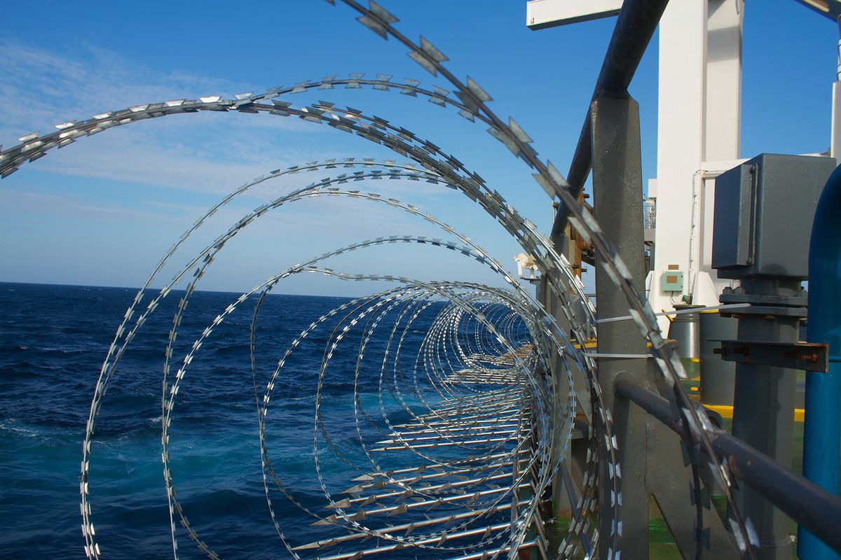 View,Of,The,Vessel,Hardening,On,Board,Ships,Using,Razor
View of the vessel hardening on board ships using razor wire and spikes, to stop pirates from boarding the ship. These ship protection measures are employed when the ship passes high risk areas