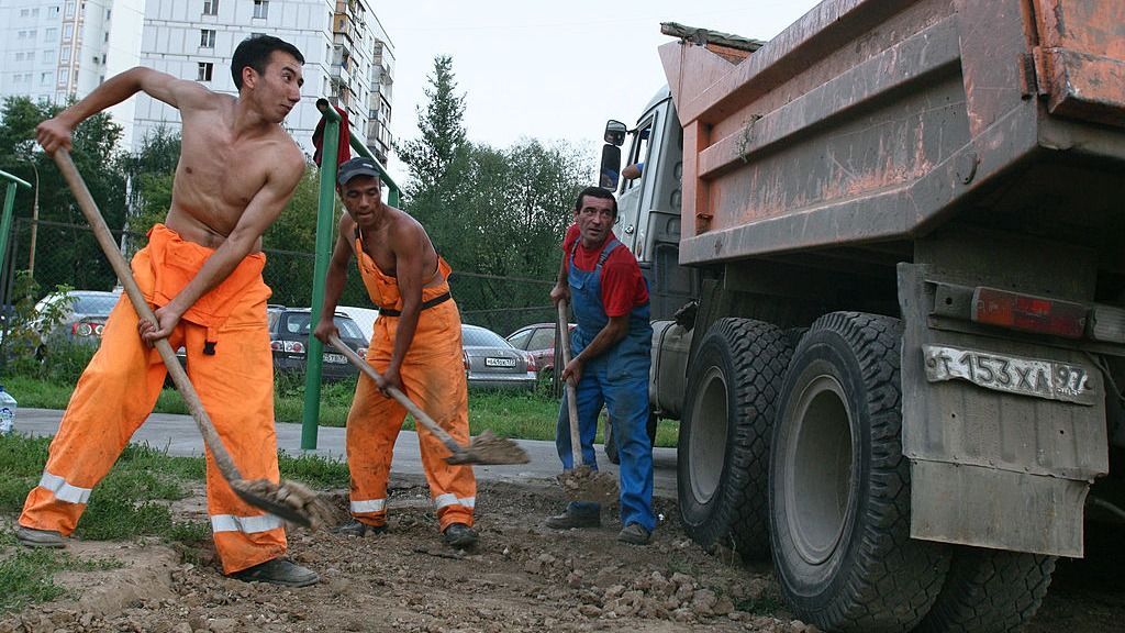 Dostmurod, a worker from Uzbekistan, left, rebuilds a road w
Maintenance crew of gasterbeiters from Uzbekistan: Dostmurod, Farhad and Islam rebuilding the road in Moscow, Russian Federation, . Photographer: Dmitry Beliakov/Bloomberg News
