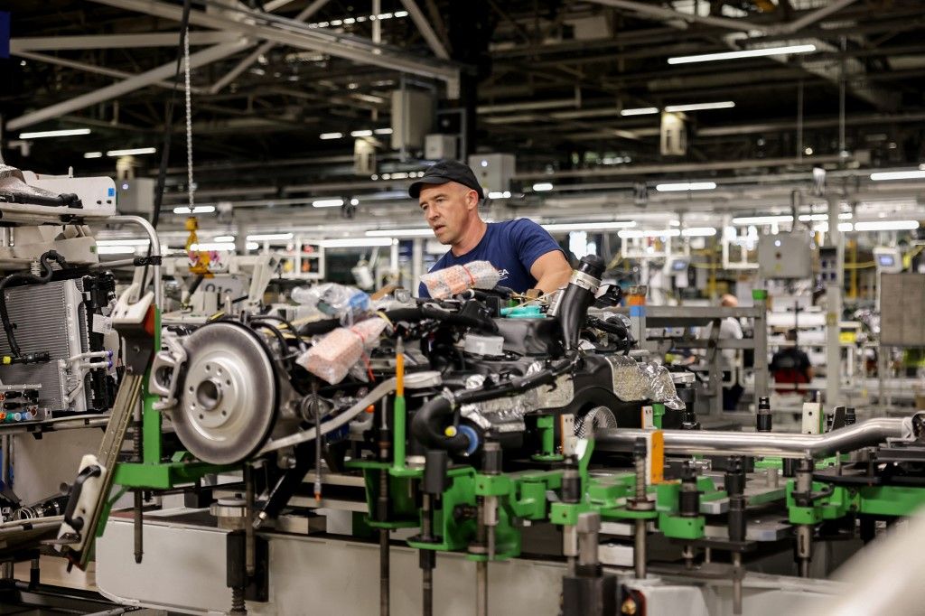 An employee is at work on the production line of the new Peugeot e-3008 electric car on September 12, 2023 at the Stellantis factory in Sochaux, France. (Photo by ARNAUD FINISTRE / AFP)
