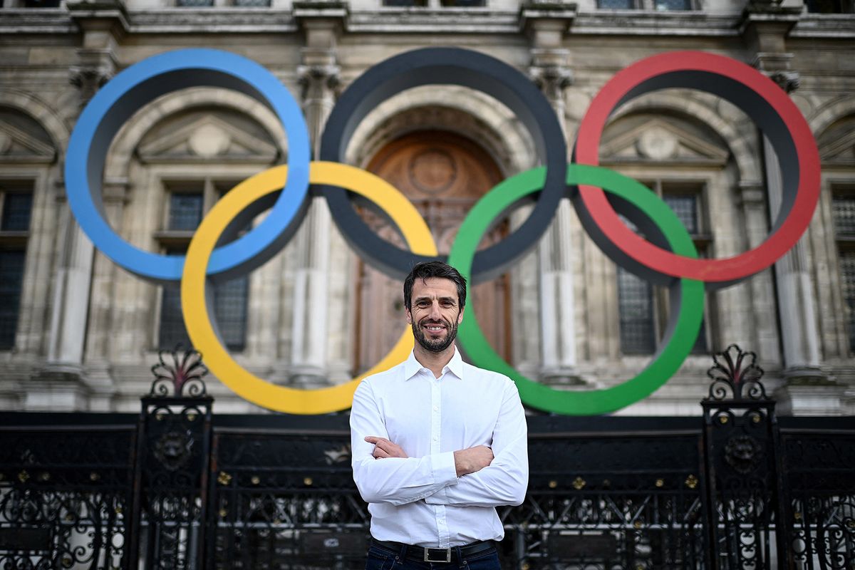 (FILES) (FILES) French President of the Paris Organising Committee of the 2024 Olympic and Paralympic Games Tony Estanguet poses in front of the Olympic rings on display over the facade of the Paris City Hall during a photo session on March 13, 2023. French investigators have opened a legal probe into the salary of Tony Estanguet, the head of the Paris Olympics organising committee, a source lose to the case told AFP on February 6, 2024. (Photo by Christophe ARCHAMBAULT / AFP)